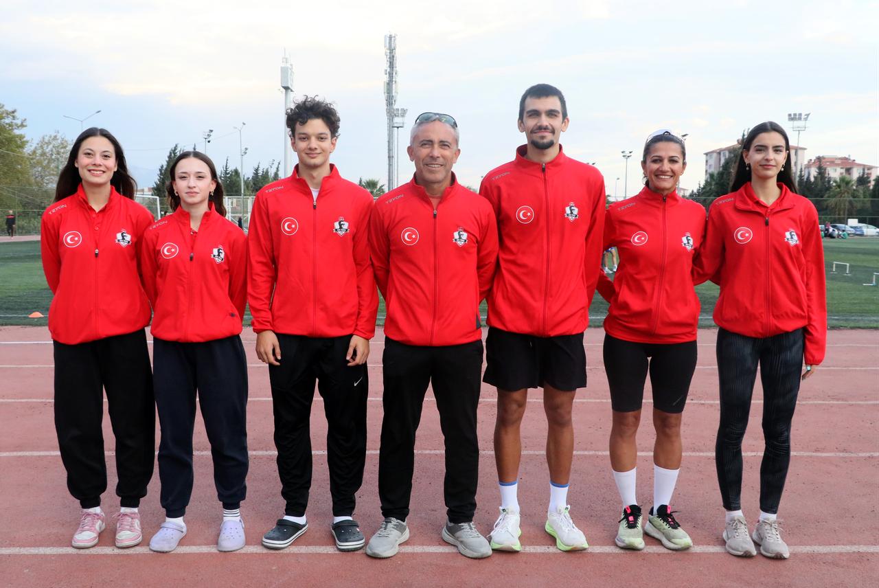 Members and coaches of a women’s athletics team pose for a group photo during preparations for Türkiye’s athletics Super League, Oct. 11, 2026. (AA Photo)