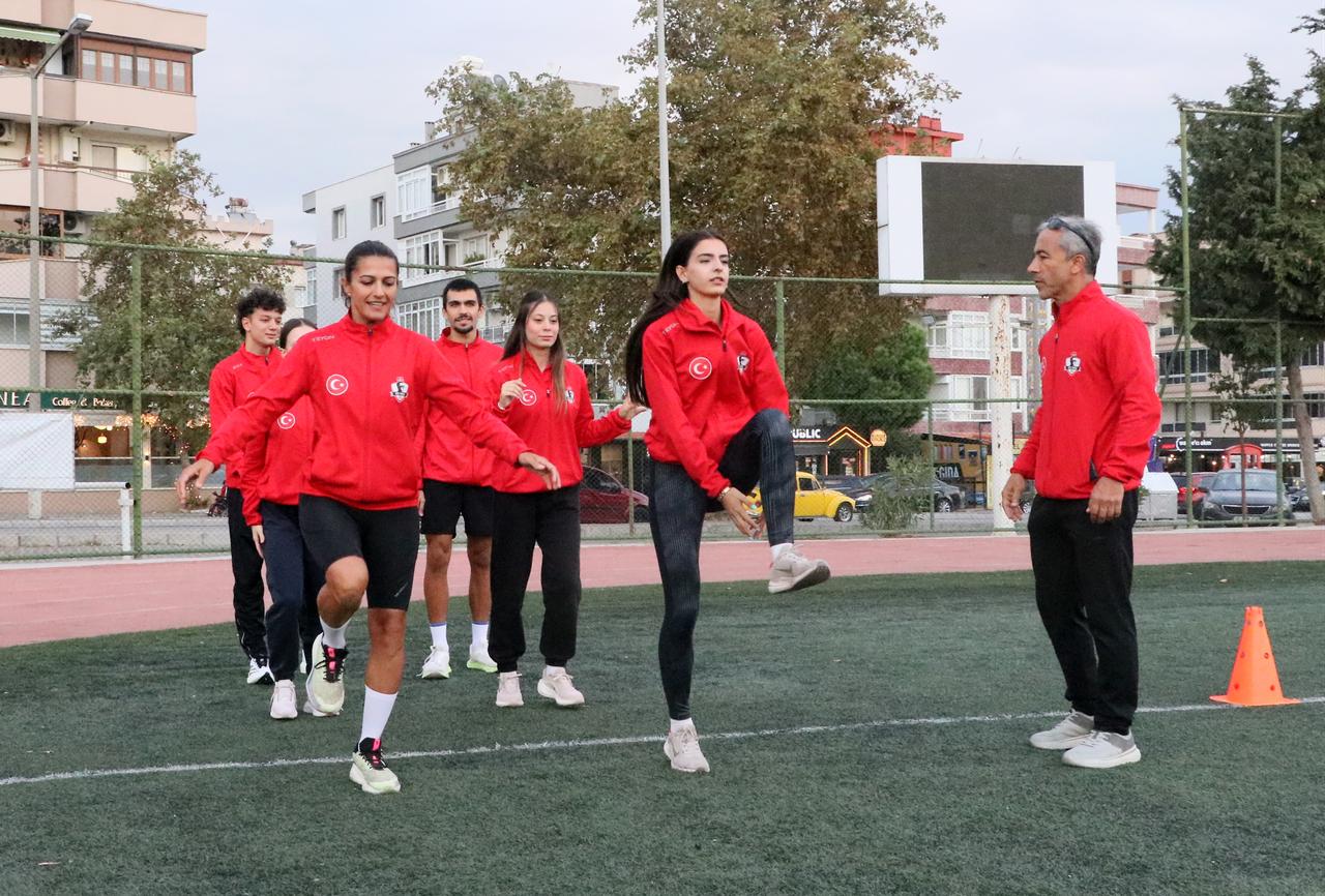 Athletes take part in running and warm-up drills under the supervision of their coach as the team prepares for Türkiye’s athletics Super League, Oct. 11, 2026. (AA Photo)