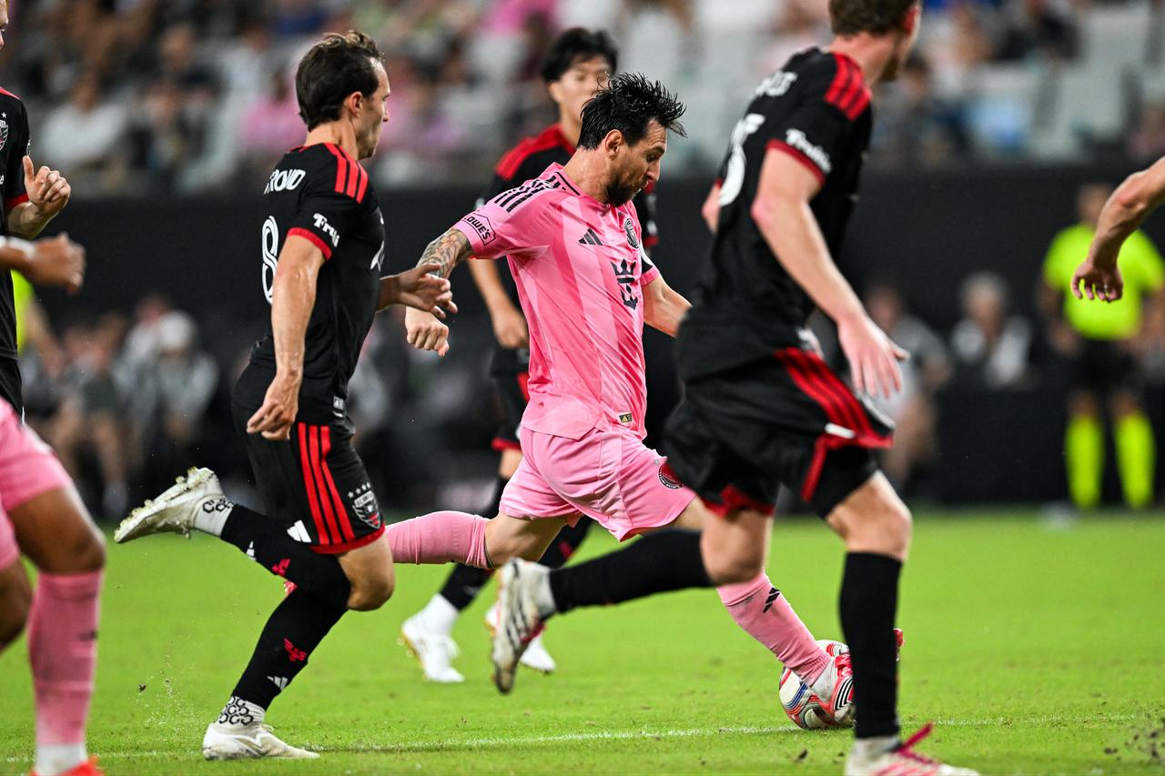Lionel Messi runs with the ball, followed by DC United's Jared Stroud, during a Major League Soccer (MLS) regular-season football match between Inter Miami CF and DC United on Oct. 10, 2026. (AFP Photo)