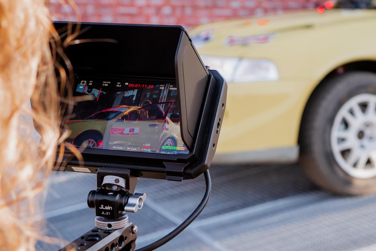 A camera monitor shows a car being filmed during a production shoot. (Adobe Stock Photo)