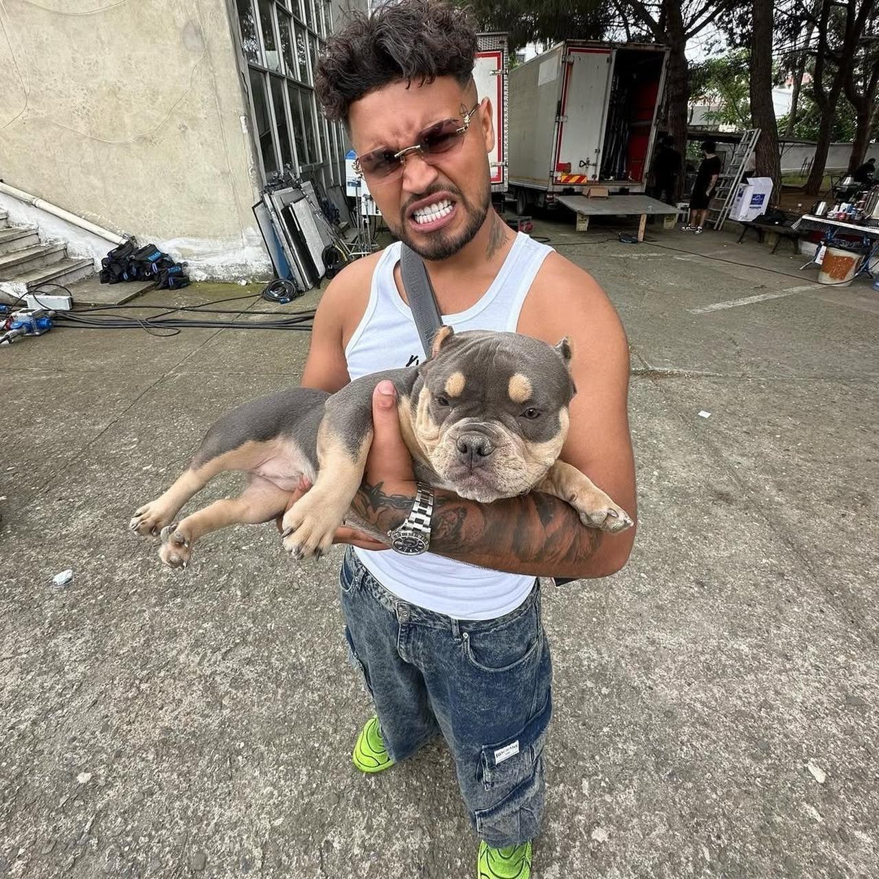 Rapper Lvbel C5 holding dog for picture. (Photo via X/@bosunatiklama)
