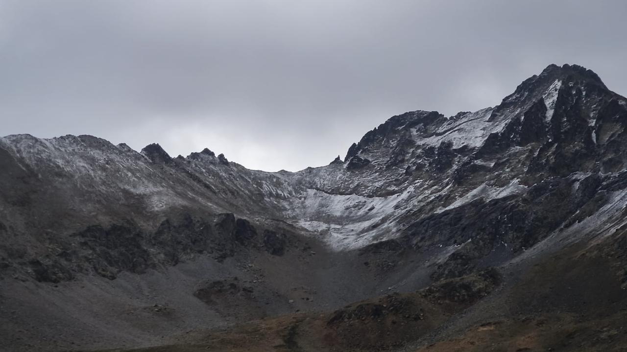 A view of rugged, snow-dusted mountain peaks under an overcast sky in the Harsit Valley defense line region. (AA Photo)