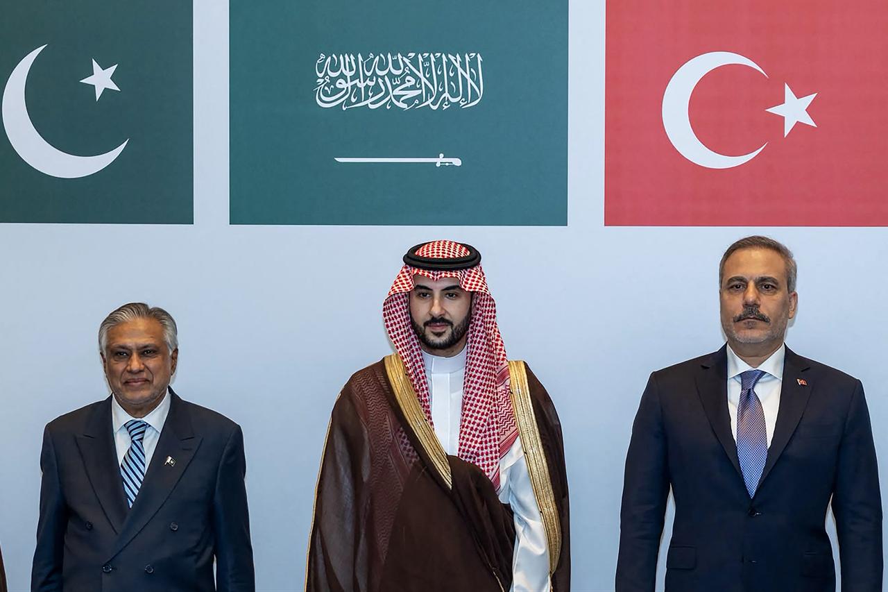 This handout photograph shows (L-R) Pakistan’s Deputy Prime Minister and Minister for Foreign Affairs Ishaq Dar, Saudi Defence Minister Prince Khalid bin Salman Al Saud and Turkish Foreign Minister Hakan Fidan posing during a meeting on October 5, 2026. (AFP Photo)