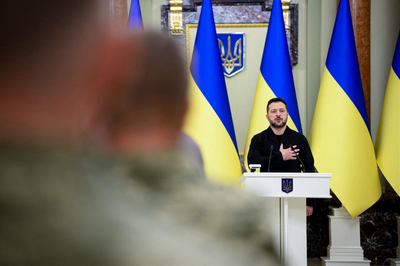 This handout photograph taken and released by the Ukrainian Presidential Press Service on October 9, 2026, shows Ukraine's President Volodymyr Zelenskyy singing Ukraine's national anthem during a ceremony in Kyiv. (AFP Photo/Handout / Ukrainian Presidential Press Service)