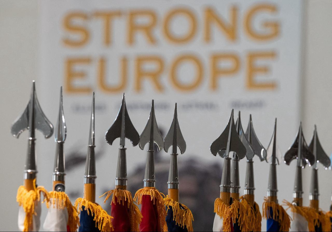 The slogan “Strong Europe” is seen on a poster behind flagpoles in the Mission Command Center at Clay Kaserne in Wiesbaden, western Germany, on October 9, 2026. (AFP Photo)