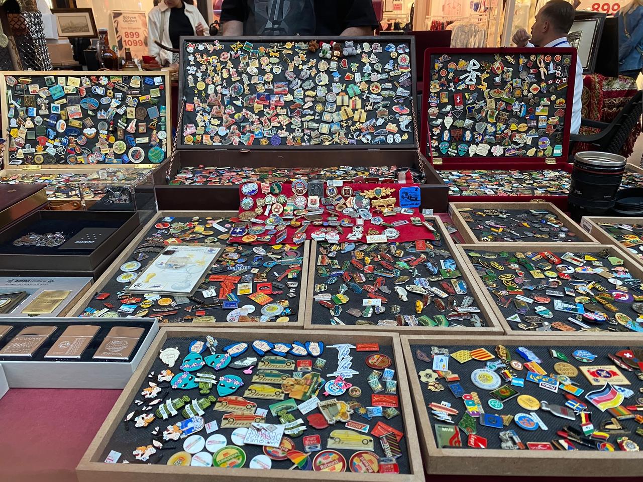 Collections of vintage pins, badges and memorabilia are displayed at an antique fair in Ankara, Türkiye, Oct. 12, 2026. (IHA Photo)