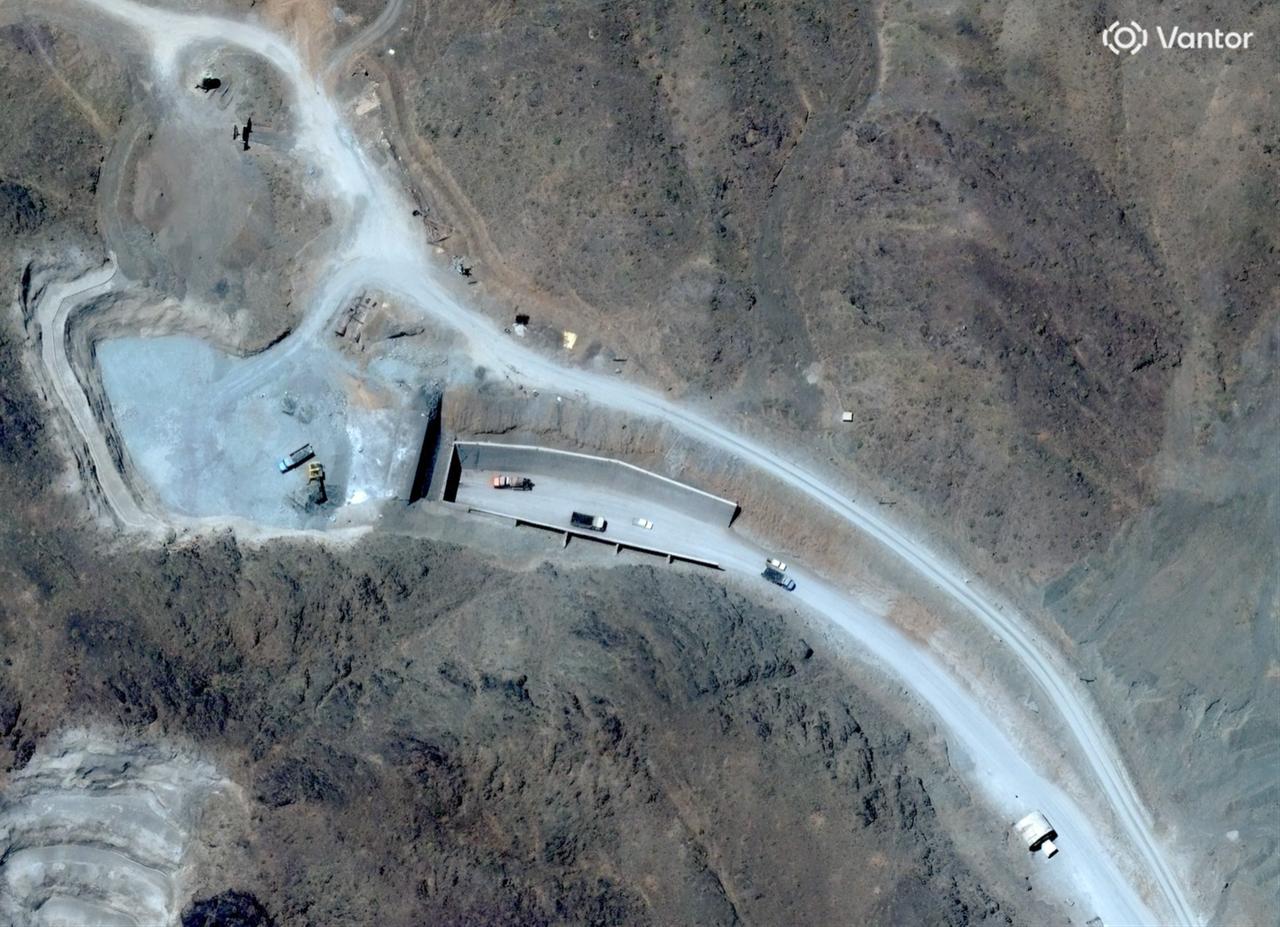 This handout satellite image courtesy of Vantor shows vehicles at the western entrance of the Pickaxe Mountain tunnel complex adjacent to the Natanz Nuclear Facility near Natanz, Isfahan province, central Iran, on June 21, 2026. (AFP Photo/Satellite image ©2026 Vantor/Handout)