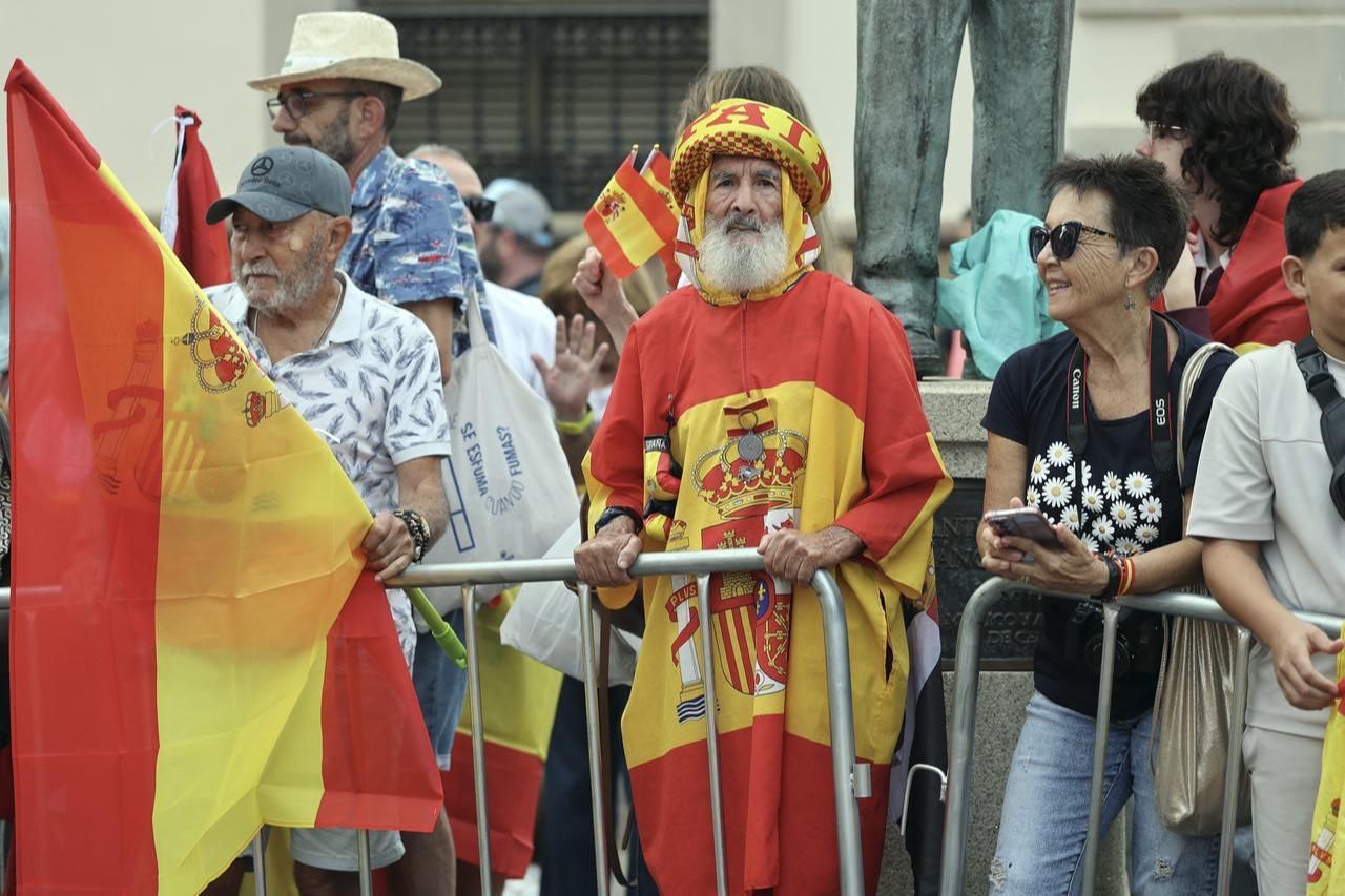 An elderly man wearing a djellaba made from a Spanish flag awaits the arrival of King Felipe VI and Queen Letizia, in the Spanish North African enclave of Ceuta, on Oct. 13, 2026. (AFP Photo)