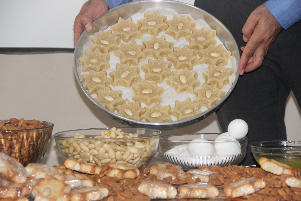A tray of unbaked Memilheva sweets is presented alongside almonds, sugar and eggs, the three ingredients used to prepare the traditional dessert, Cizre, Türkiye, October 14, 2026. (IHA Photo)