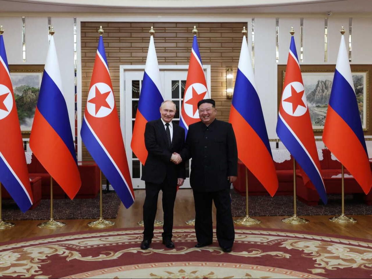 In this pool photograph distributed by the Russian state agency Sputnik, Russia's President Vladimir Putin (L) shakes hands with North Korea's leader Kim Jong Un during a meeting in Pyongyang on June 19, 2024. (Photo by Sputnik / AFP)