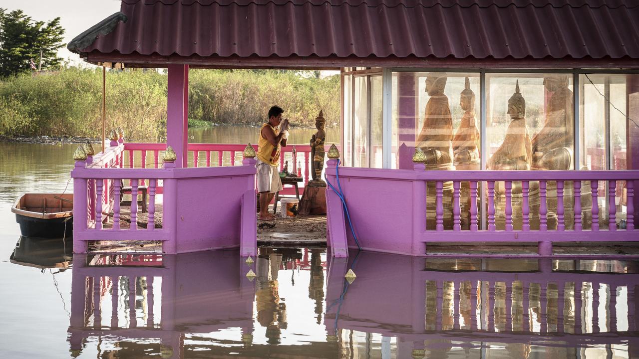 Thai villagers raise stilt houses as floods are diverted from Bangkok