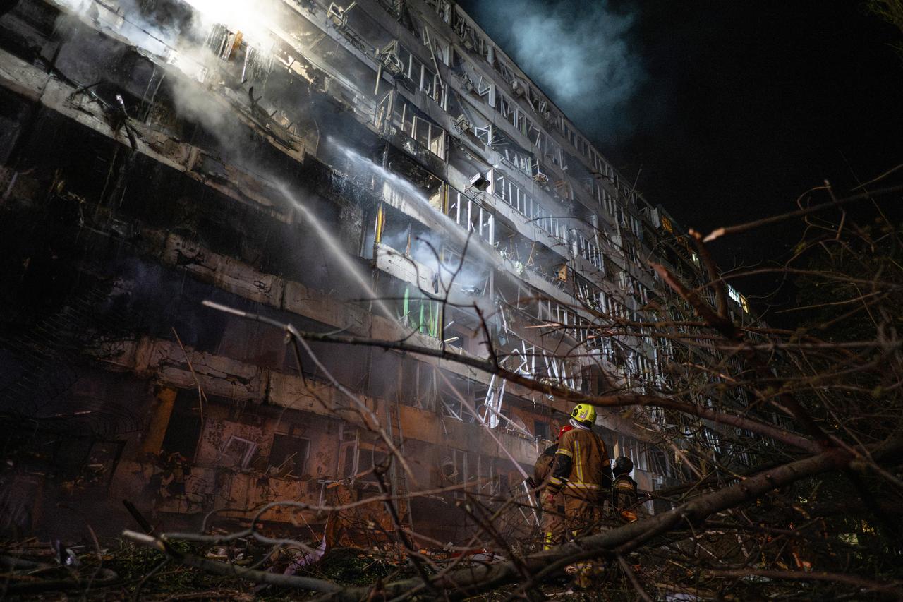 Ukrainian firefighters extinguish a blaze at the site of a Russian missile strike at an apartment building in Kyiv on October 14, 2026, amid the Russian invasion of Ukraine. (AFP Photo)
