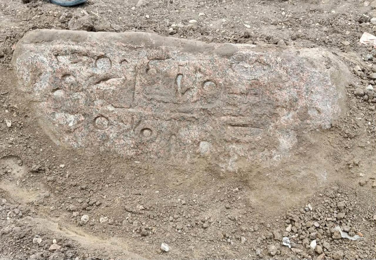 A pink granite block bearing ancient Egyptian hieroglyphic inscriptions, including royal titles of Ramses II, is uncovered during archaeological excavations in Behbeit el-Hagar, Egypt. (Photo via Egypt's Ministry of Tourism and Antiquities)