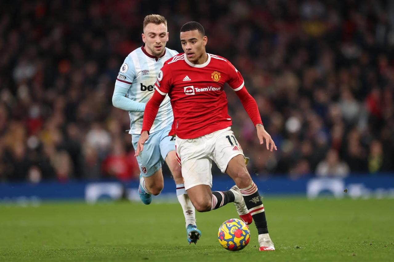 Mason Greenwood of Manchester United battles for possession with Jarrod Bowen of West Ham United during the Premier League match between Manchester United and West Ham United at Old Trafford on January 22, 2022 in Manchester, England. (Photo by Naomi Baker)