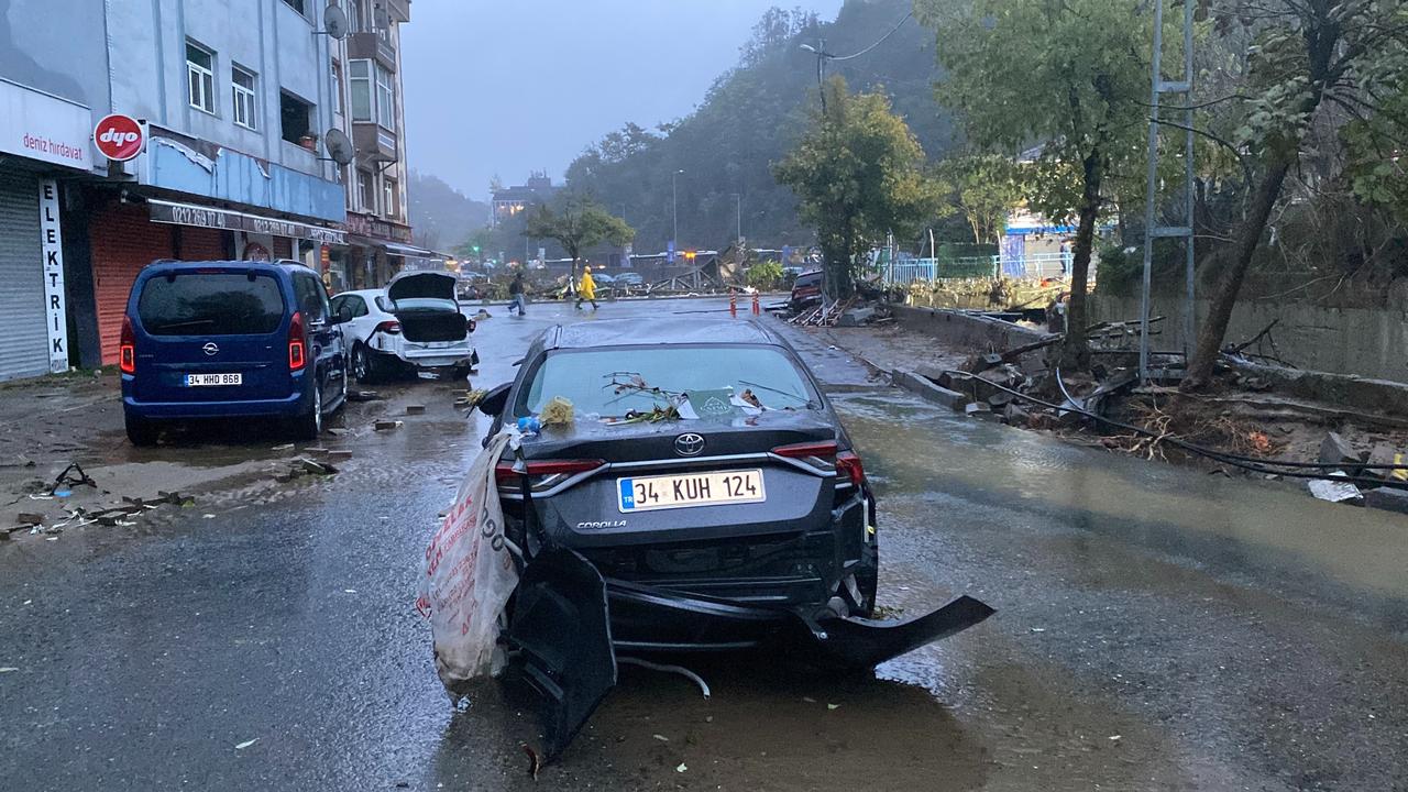 A car damaged by severe flooding is seen on a debris-covered street in Istanbul, Türkiye, following heavy rainfall that battered the city the previous day, October 15, 2026. (IHA Photo)