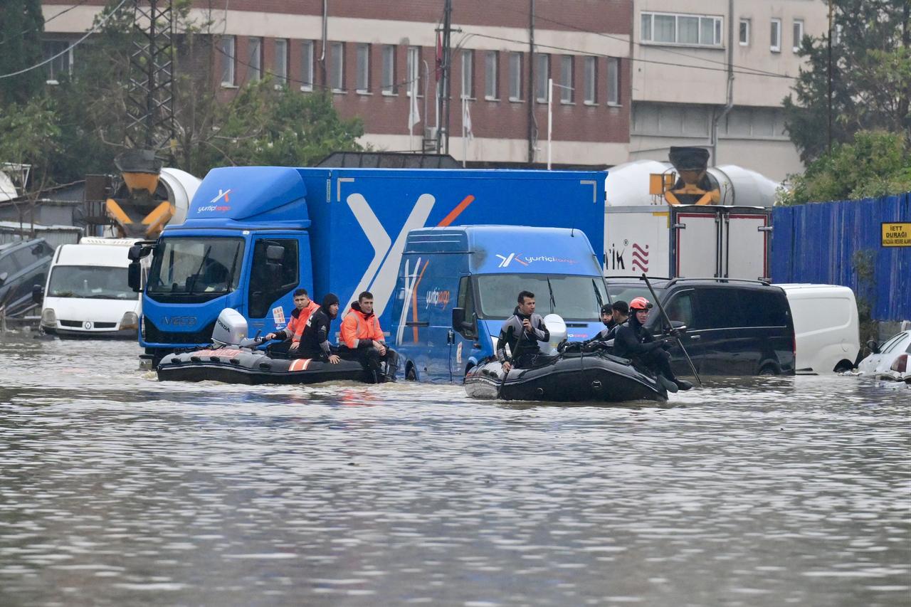People stranded inside businesses are evacuated with the help of boats as heavy rainfall causes flooding in the Ayazaga neighborhood of Istanbul, Türkiye, on October 15, 2026. (AA Photo)