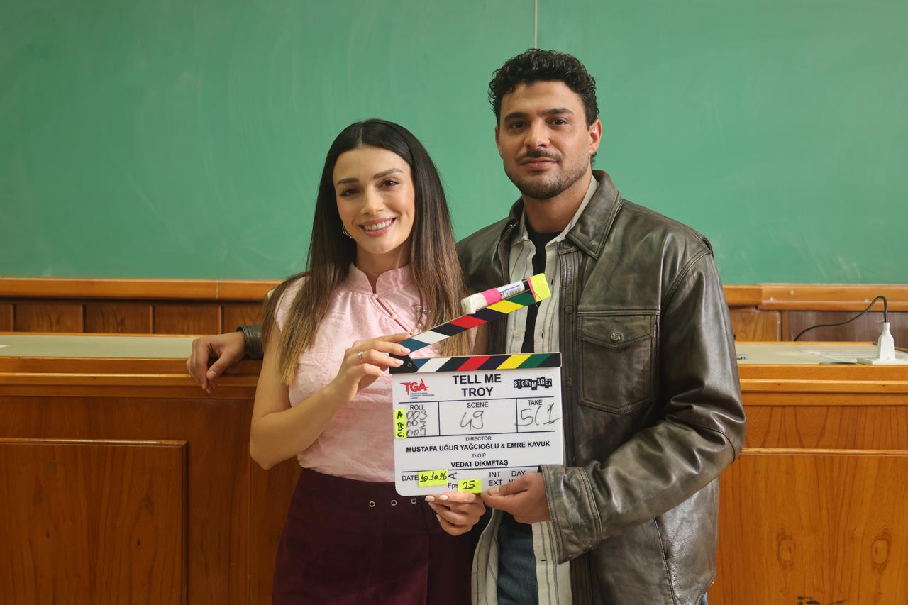 Lead actors Ozge Yagiz and Halit Ozgur Sari pose with a clapperboard on the set of Go Türkiye's new mini-series "Tell Me Troy." (Photo via Go Türkiye)