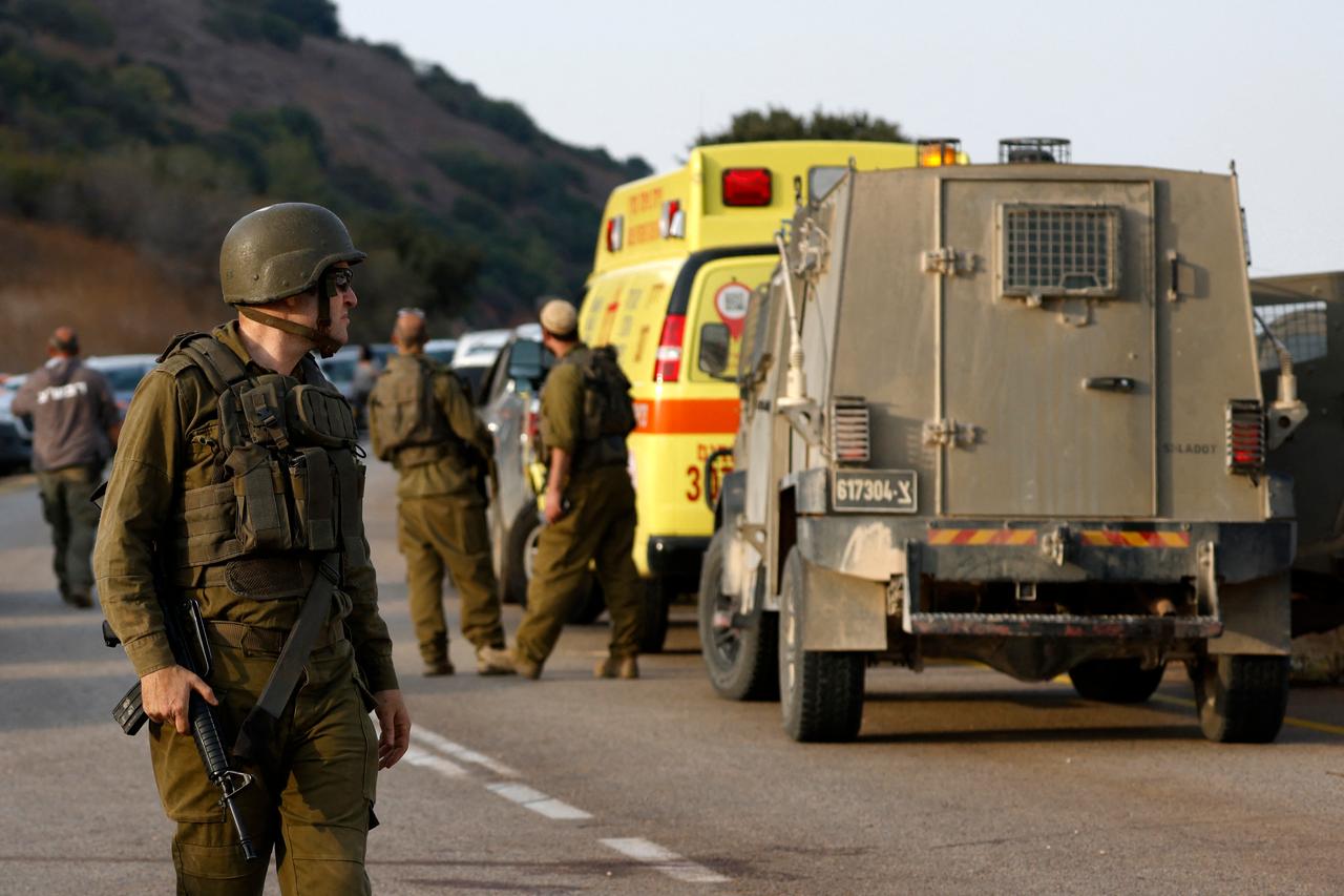 Israeli soldiers gather near the site of an explosion on the outskirts of Yiftah near the Lebanese border, in northern Israel, October 12, 2026. (AFP Photo)