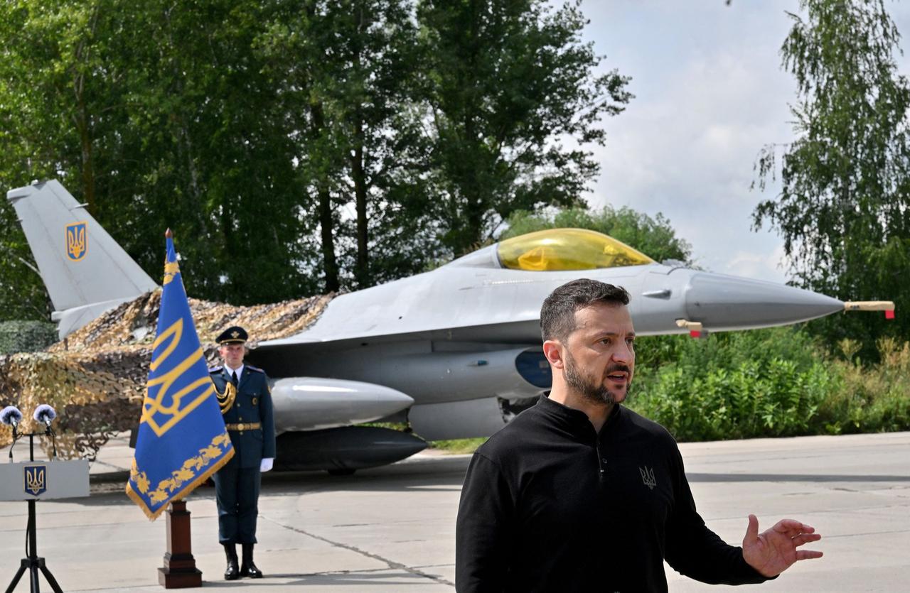 Ukrainian military member stands next to the first General Dynamics F-16 Fighting Falcon received by Ukraine, on the Day of Ukrainian Air Force on August 4, 2024 in Unspecified, Ukraine. (AFP Photo)