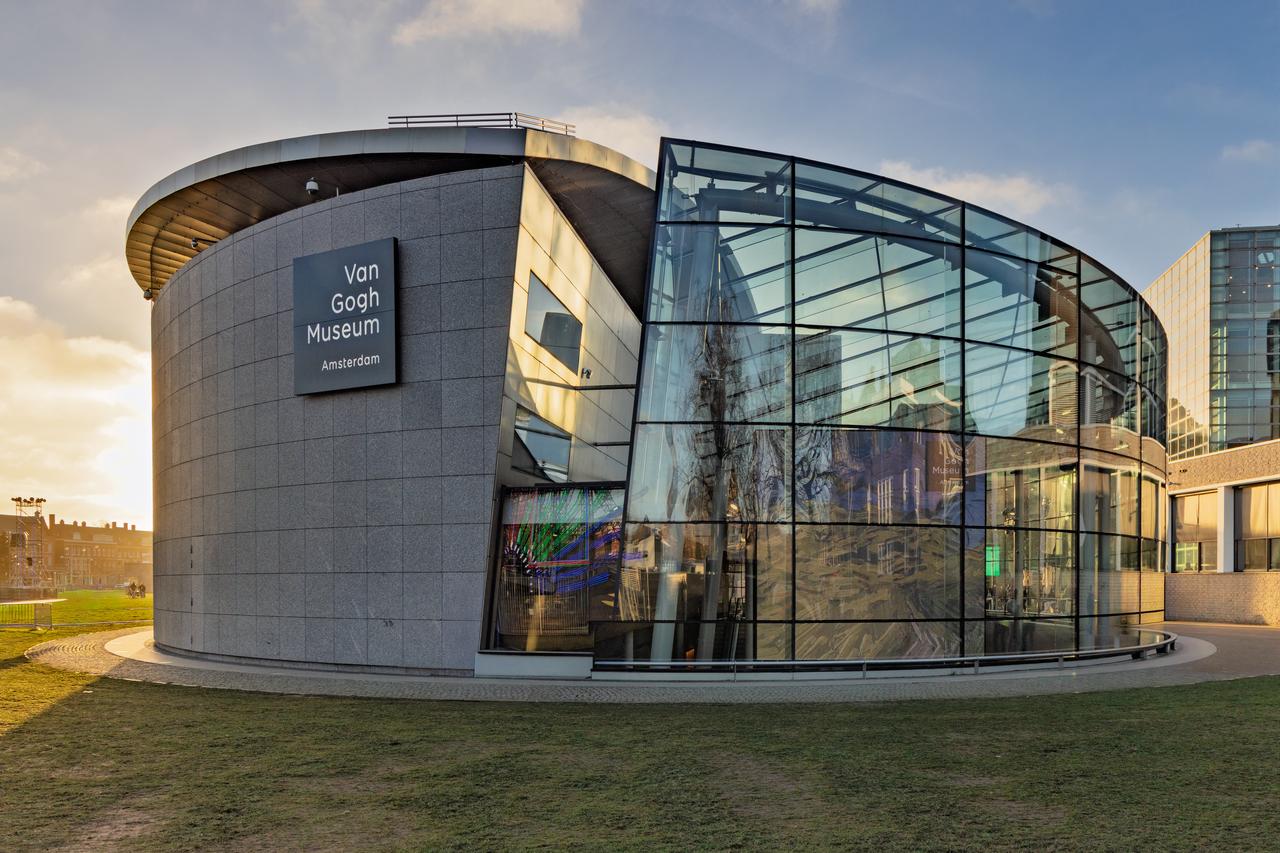 Modern glass entrance hall of the Van Gogh Museum during sunset, Amsterdam, Netherlands. (Adobe Stock photo)