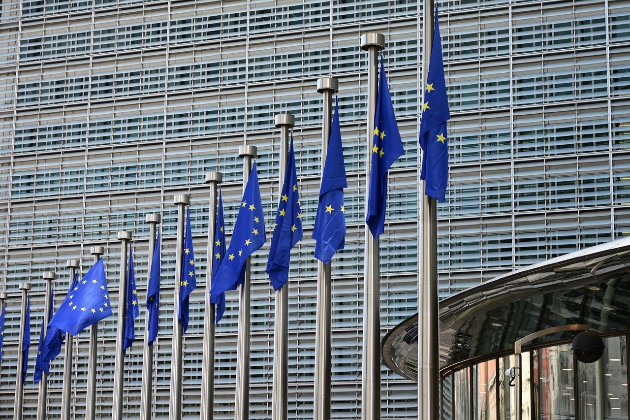 This photograph shows European flags fluttering outside the Berlaymont building, the EU Commission headquarters, in Brussels on October 2, 2026. (AFP Photo)