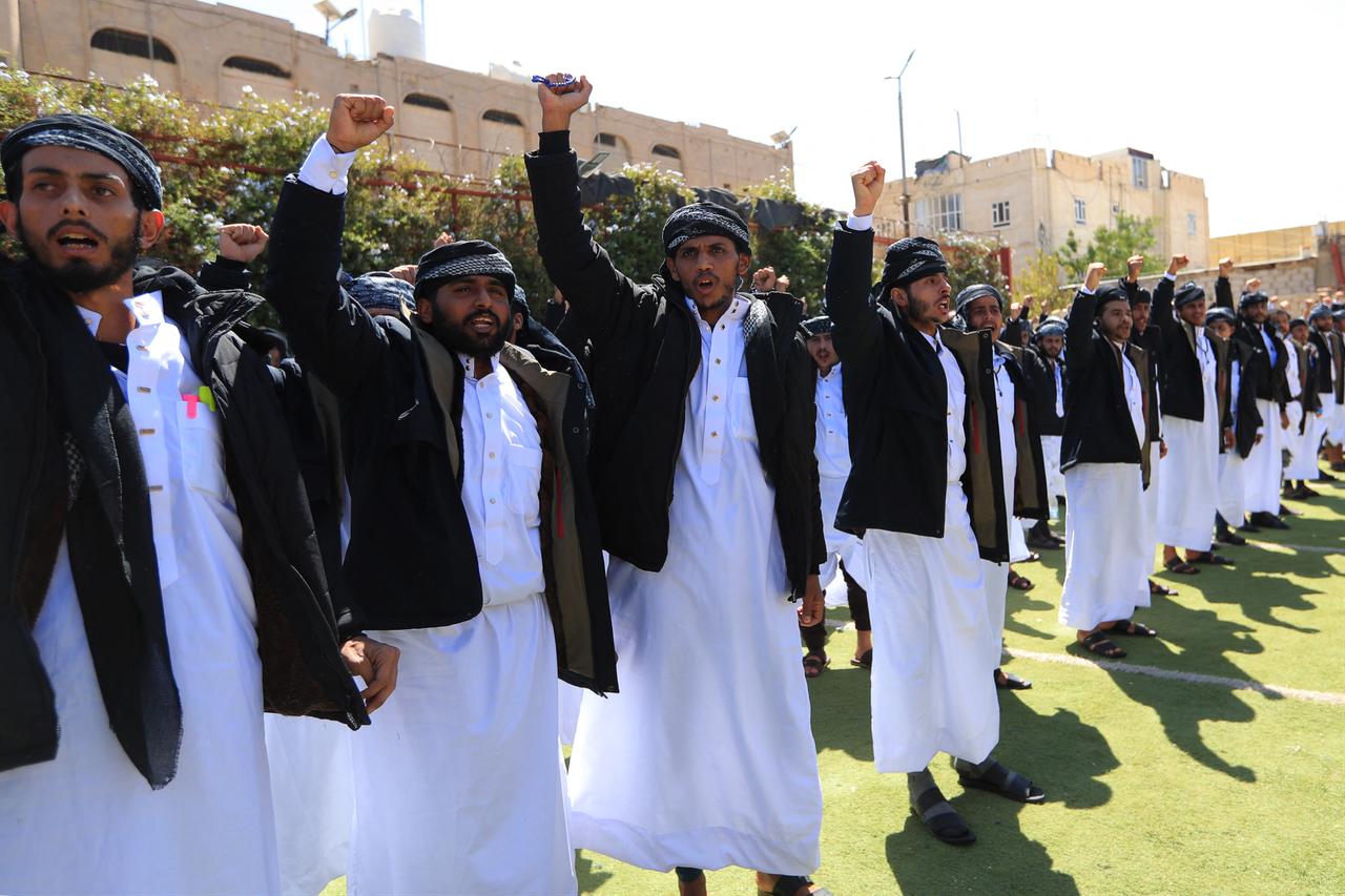 Newly-released prisoners gesture as they wait to be united with their relatives, in Yemen's Houthi-controlled capital Sanaa on Oct. 17, 2026. (AFP Photo)