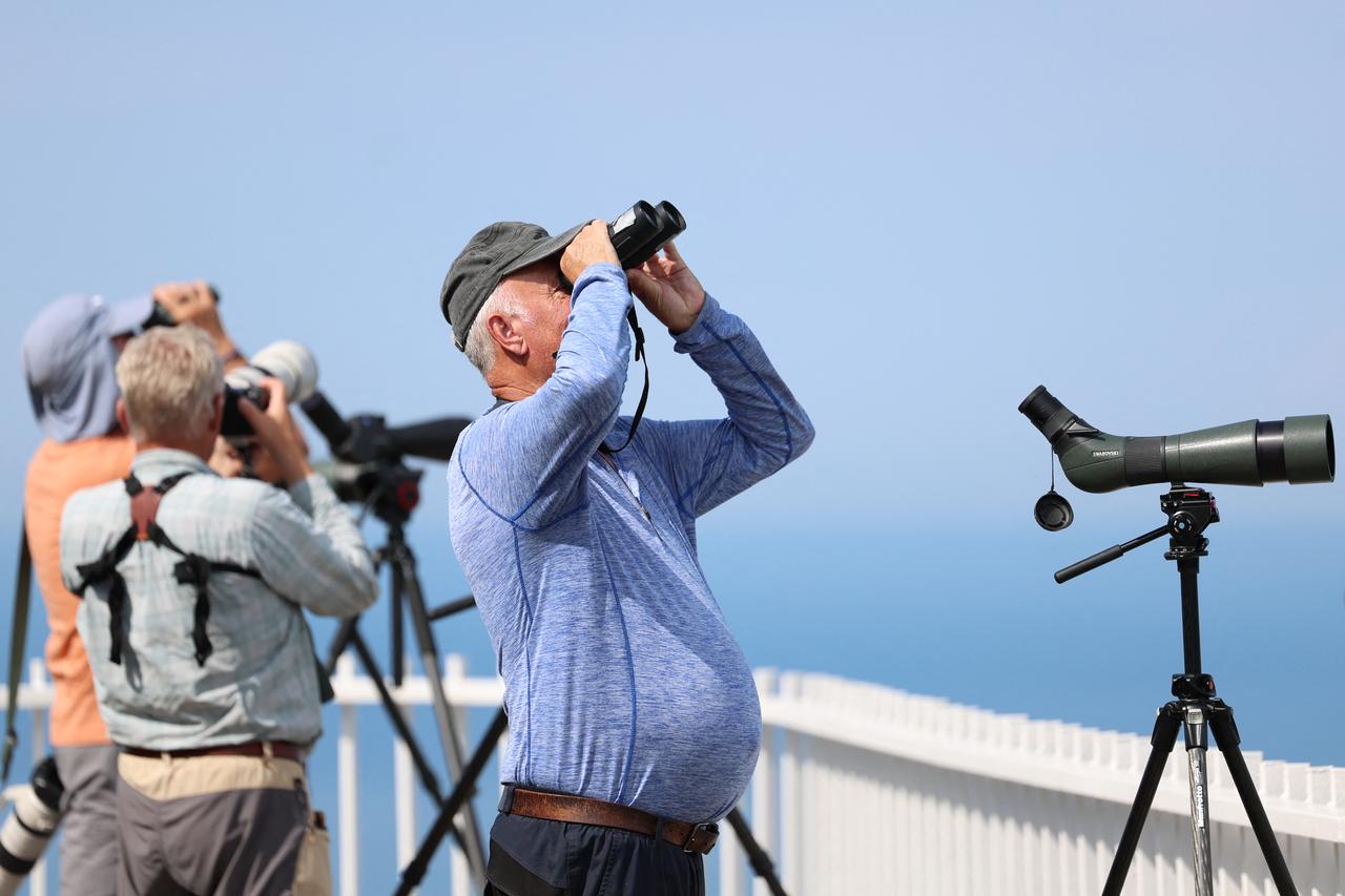 Birdwatchers scan the sky for migrating raptors at an observation point near Batumi, Georgia, Sep. 22, 2026. (AFP Photo)