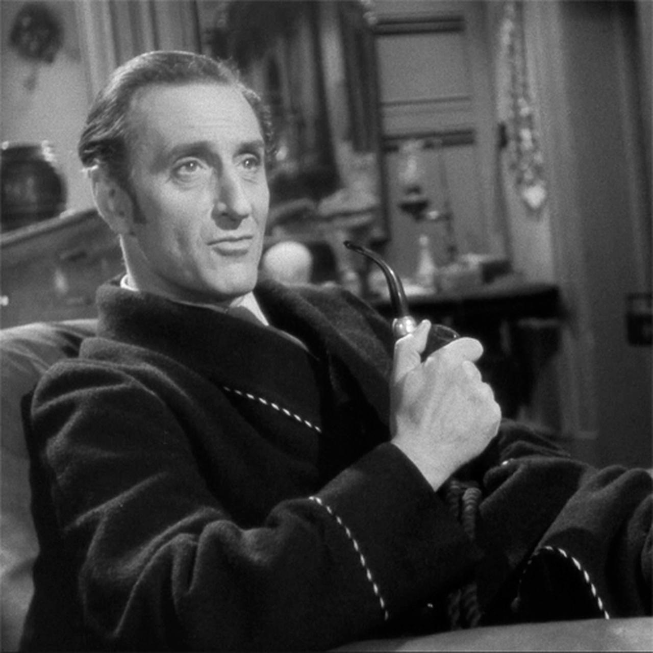 British actor Basil Rathbone portrays detective Sherlock Holmes while holding a pipe in a scene from the Sherlock Holmes film series. (Archive Photo)
