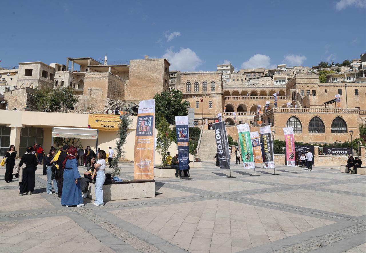 Visitors gather at a festival venue in front of Mardin's historic stone buildings during the Türkiye Culture Route Festival in Mardin, Türkiye, Oct. 17, 2026. (AA Photo)