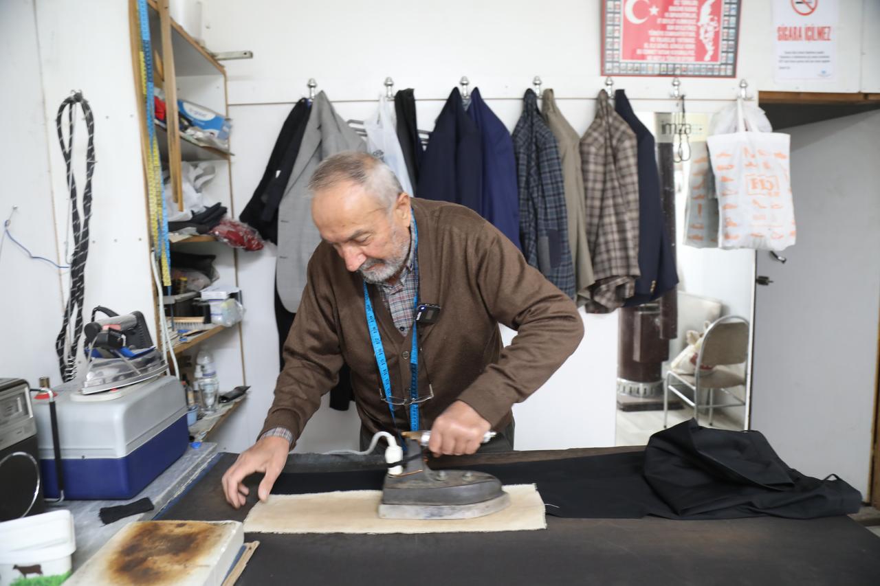 A 74-year-old tailor irons a garment at his workshop in Cubuk, Ankara, Türkiye, Oct. 18, 2026. (AA Photo)