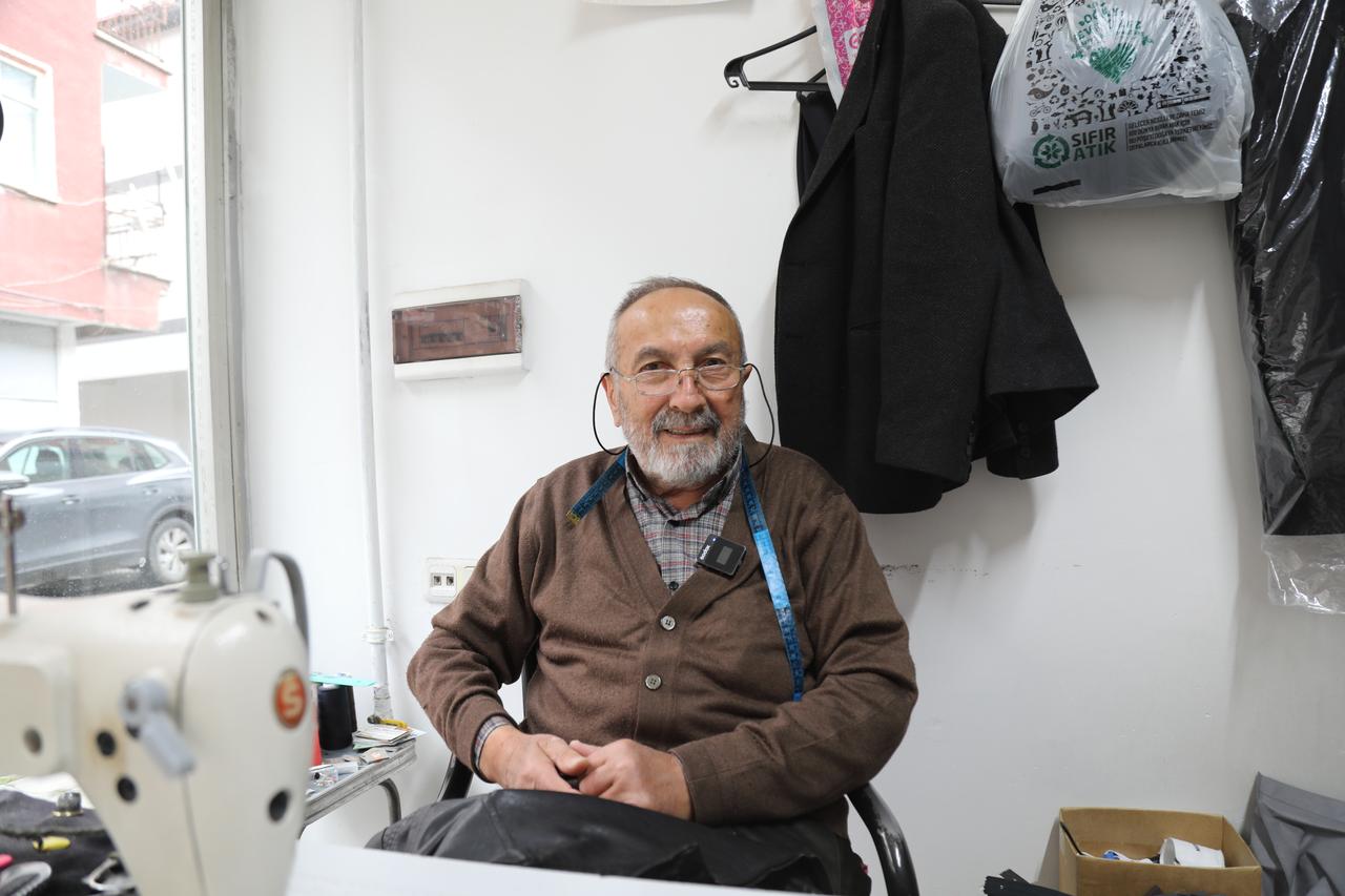 A 74-year-old tailor who has worked in the profession for 61 years sits beside his sewing machine at his shop in Cubuk, Ankara, Türkiye, Oct. 18, 2026. (AA Photo)