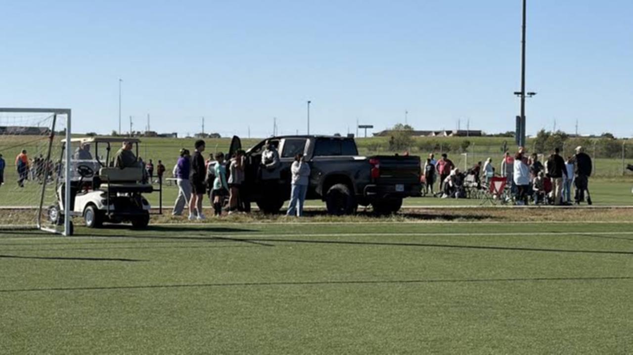 People gather around the pickup truck involved in a deadly crash at the Stryker Sports Complex in Wichita, Kansas, on Oct. 17, 2026. (Photo via Facebook)