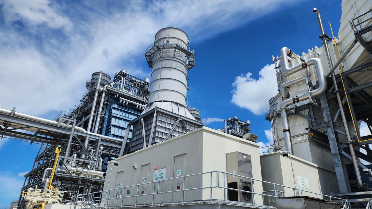 Industrial turbines, exhaust stacks and pipelines are seen at a natural gas-fired power plant. (Adobe Stock Photo)