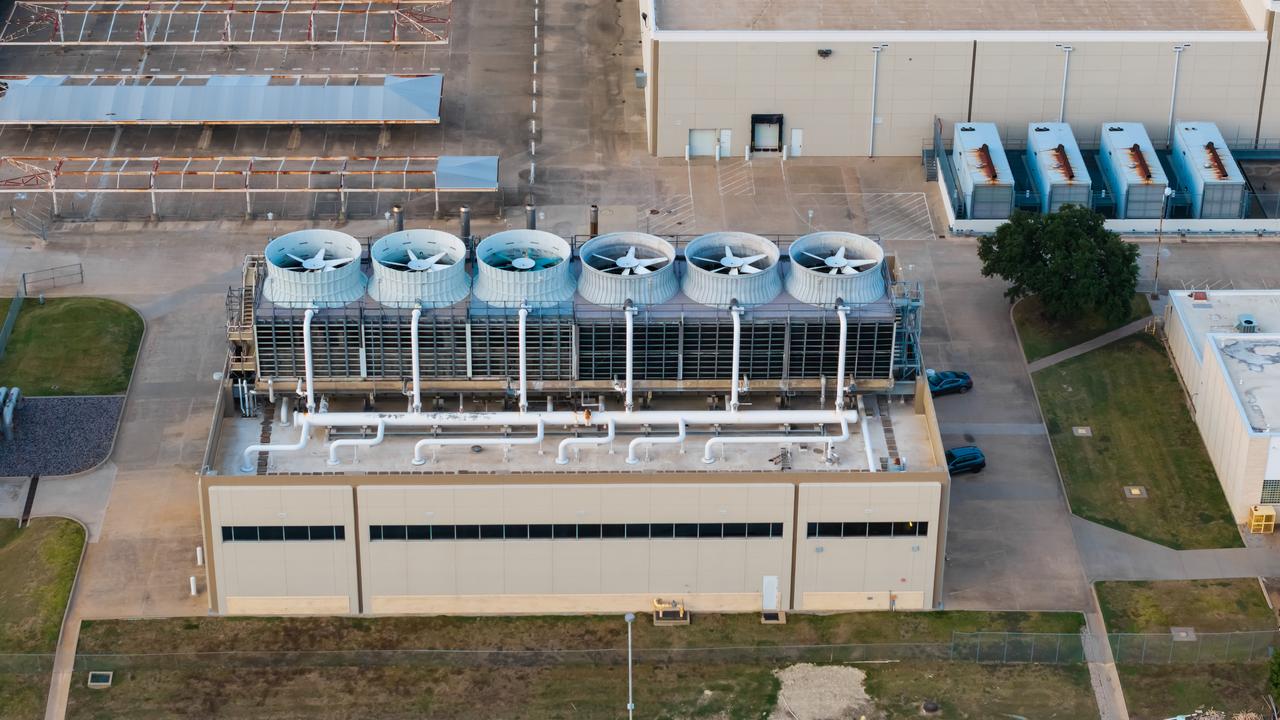 An aerial view shows industrial cooling towers and ventilation equipment installed at a data center complex. (Adobe Stock Photo)