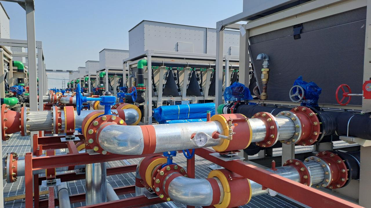 Cooling systems, industrial pipelines and control valves are installed at a data center facility. (Adobe Stock Photo)