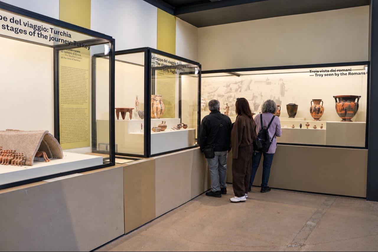 Visitors examine ancient artifacts on display at the "Troy and Rome: Myths, Legends and Stories of the Ancient Mediterranean" exhibition at the Colosseum in Rome, Italy, on October 19, 2026. (AA Photo)