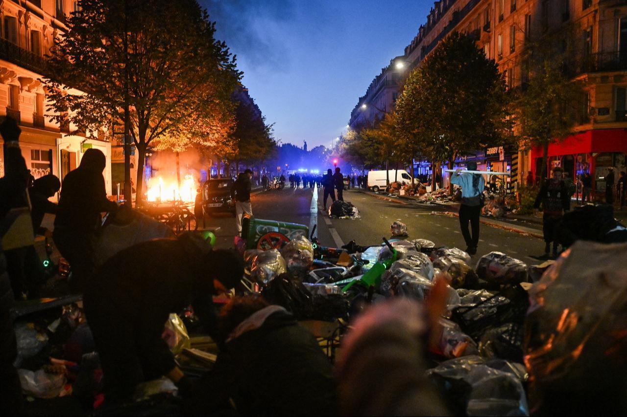 Protestors put objects such as trashes or bike on the Boulevard Voltaire as clashes erupted at Place de la Republique following an demonstrations, central Paris, on Oct. 18, 2026. (AFP Photo)