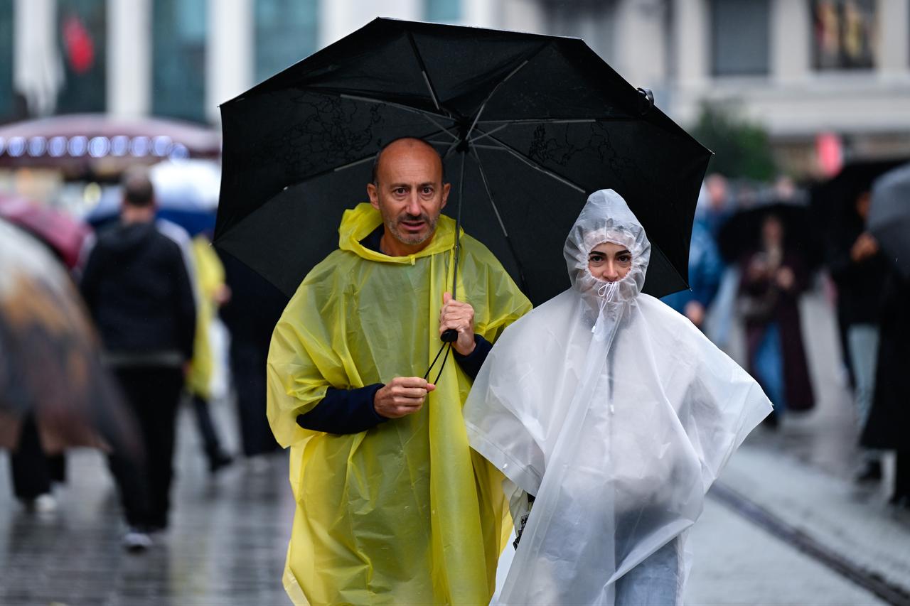 People use umbrellas to shield themselves from intermittent rainfall on Istiklal Street in Istanbul, Türkiye, on Oct. 15, 2026. (AA Photo)