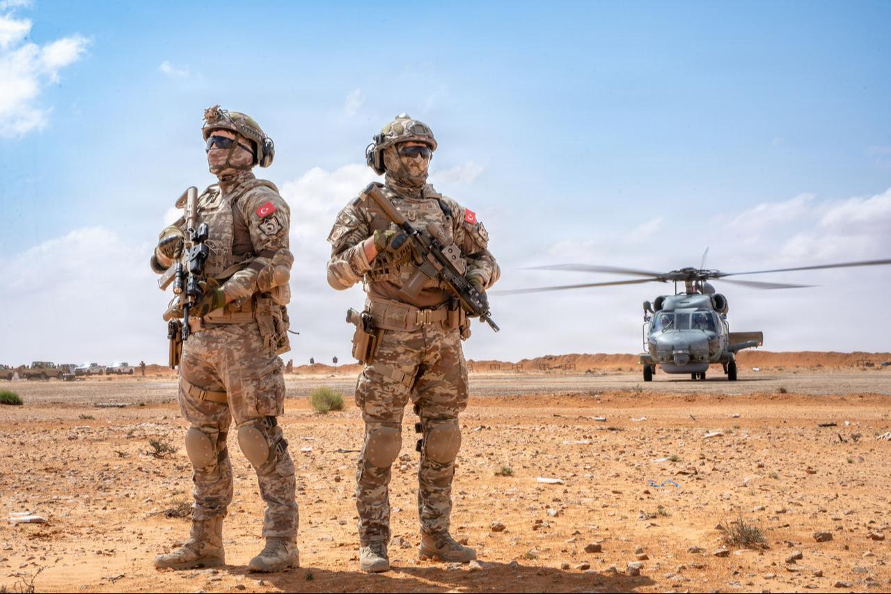 Members of the Turkish armed forces stand beside a Turkish Navy SeaHawk S-70B-2 after fast rope training at Flintlock 2026 in Sirte, Libya, April 17, 2026. (Photo via U.S. Air Force)