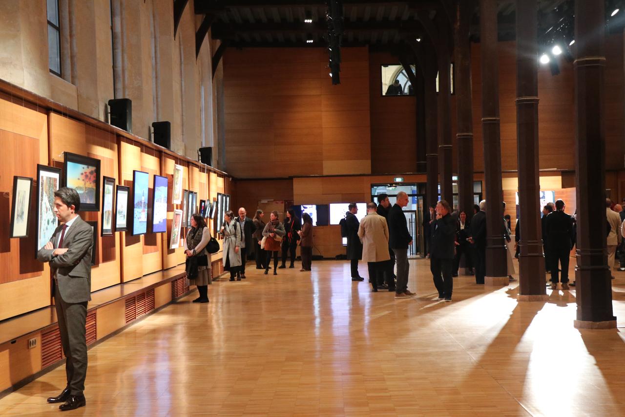 Visitors explore artworks depicting Istanbul's architecture and cityscapes during the "Istanbul: One City, A Thousand Perspectives" exhibition in Paris, France, Oct. 19, 2026. (AA Photo)