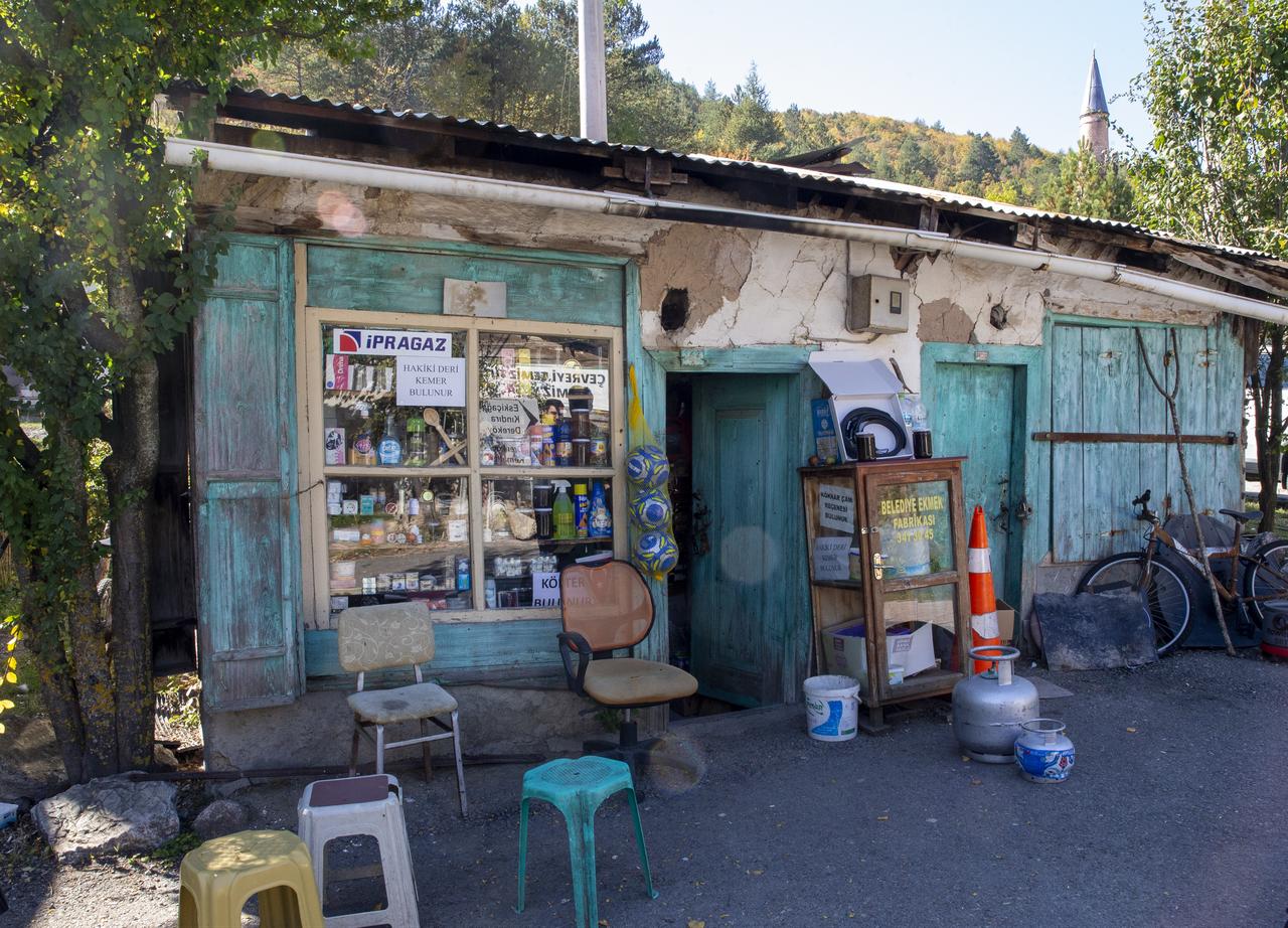 The exterior of a nearly 120-year-old grocery store, operated by the same family for four generations, features weathered wooden doors and shelves of everyday goods in Türkiye, Oct. 19, 2026. (AA Photo)