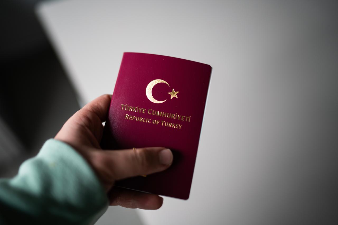A person holds a Turkish passport. (Adobe Stock Photo)