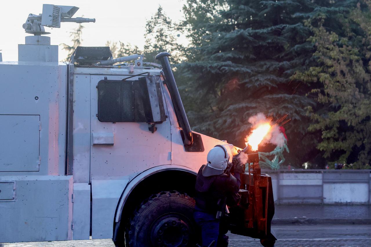 A police officer fires a teargas against protesters during an anti-government demonstration in central Tirana on October 20, 2026. (AFP Photo)