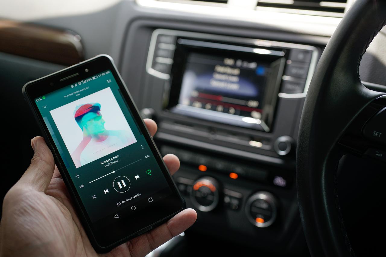 User browse trending music sync with Car Bluetooth Audio. (Adobe Stock photo)