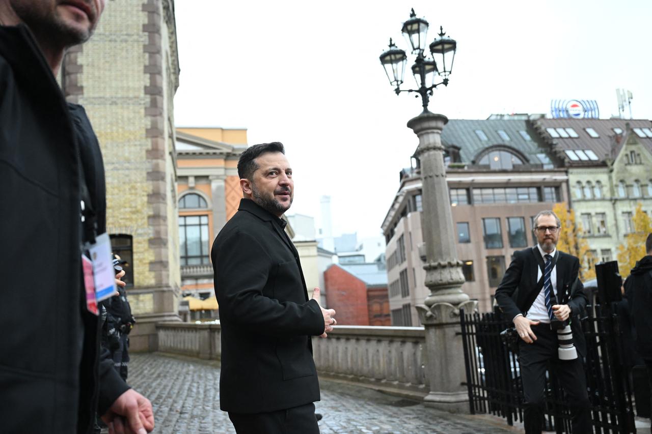 Ukraine's President Volodymyr Zelensky (C) leaves Norway's Parliament (Storting), where he attended a session on October 21, 2026, one day after a meeting in the Norwegian capital on the situation in Ukraine. (AFP Photo)