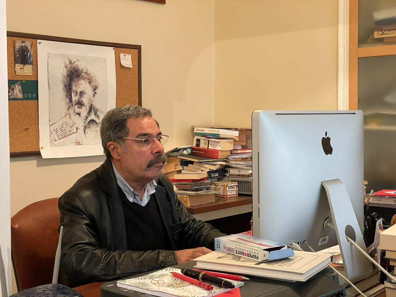 Turkish crime novelist Ahmet Umit works at his desk, surrounded by books and manuscripts, in his Istanbul office, Türkiye, Oct. 19, 2026. (Photo by Türkiye Today team)