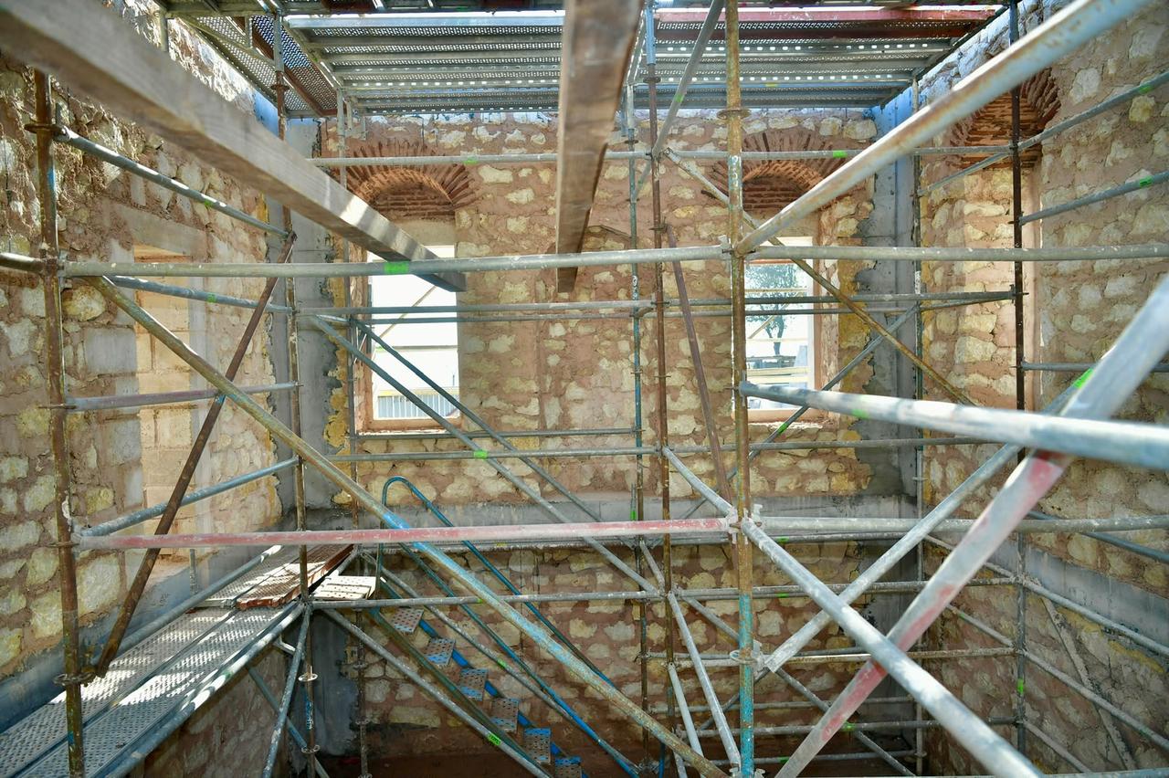 Scaffolding surrounds the interior stone walls of the Bostancilar Tabhanesi Mosque as reconstruction continues nearly 70 years after its demolition in Istanbul, Türkiye, October 22, 2026. (AA Photo)