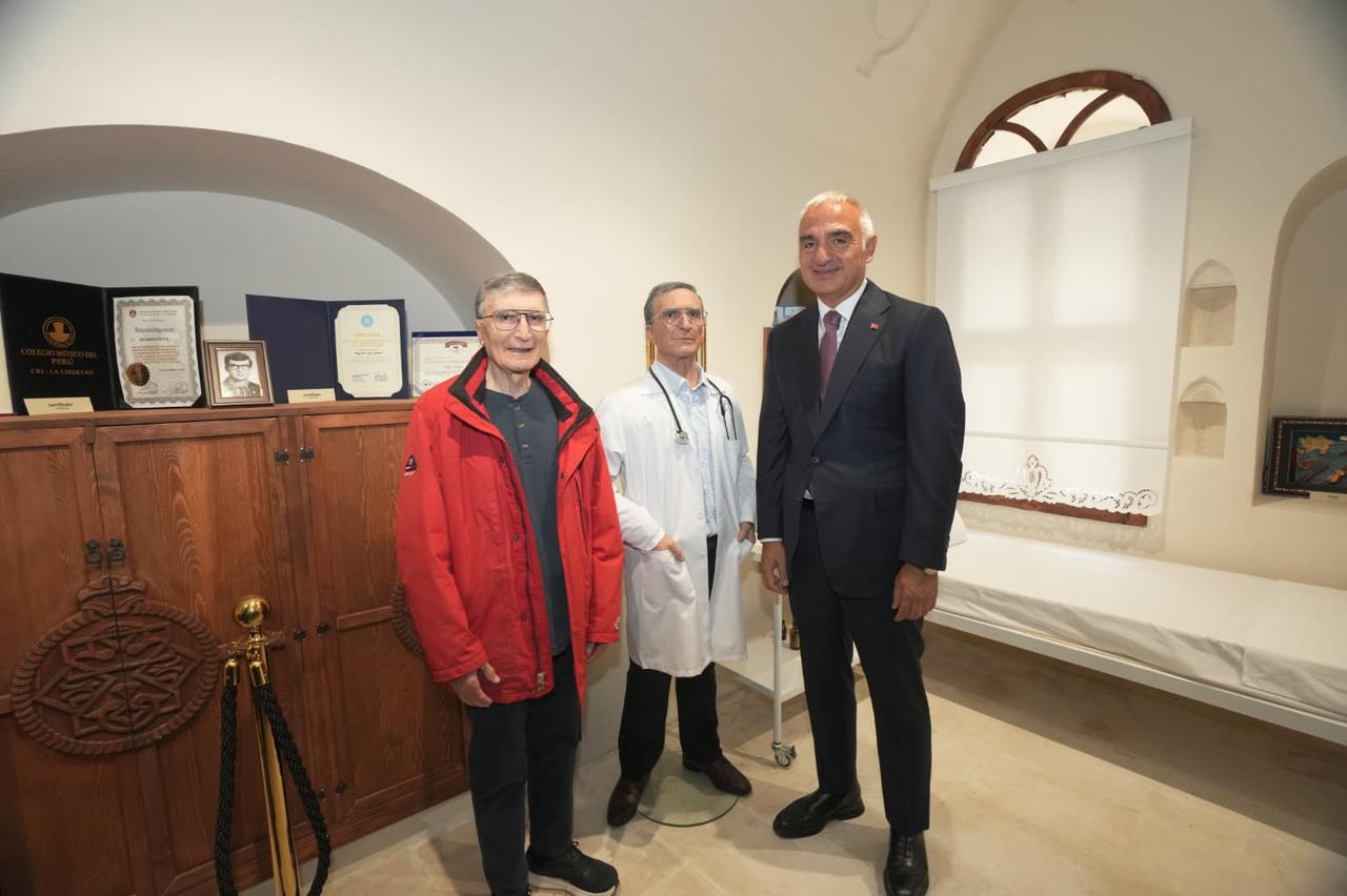 Nobel Prize-winning scientist Aziz Sancar and Culture and Tourism Minister Mehmet Nuri Ersoy pose inside a room displaying medical equipment and academic documents at the Aziz Sancar Museum in Savur, Mardin, Türkiye, October 21, 2026. (AA Photo)