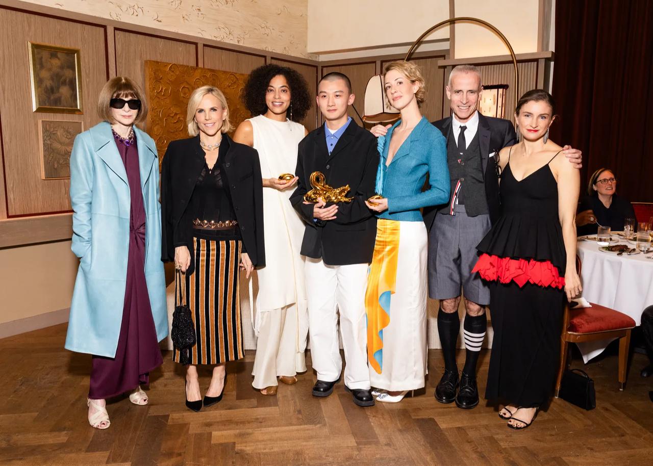 Anna Wintour, Tory Burch, Aisling Camps, Zane Li, Emily Dawn Long, Thom Browne and Chloe Malle pose together at the 2026 CFDA/Vogue Fashion Fund winners announcement dinner in New York. (Photo by Yvonne Tnt/BFA.com)