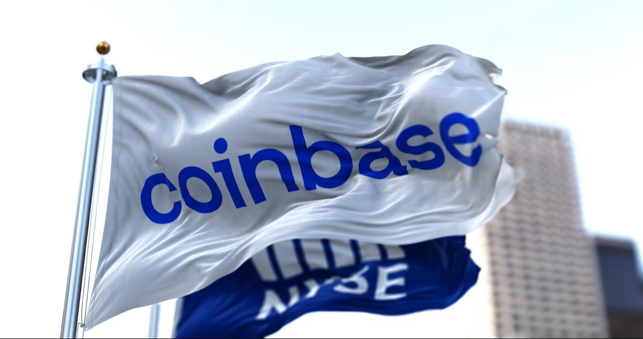 Flags bearing the Coinbase and New York Stock Exchange (NYSE) logos fly outside a building in New York City on April 14, 2021. (Adobe Stock Photo)